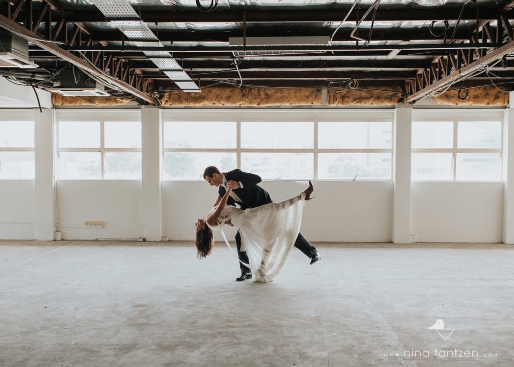 couple dancing tango in empty industrial building