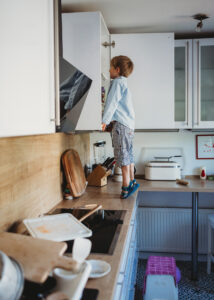 Boy climbs on kitchen counter