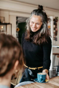 personal branding cafe owner serving coffee
