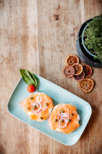 plate with bagel and salmon on a wooden table