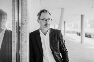 personal branding man in suit leaning on wall